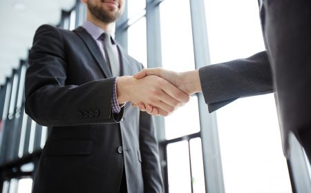 Handshake of successful business partners in formalwear after making agreement